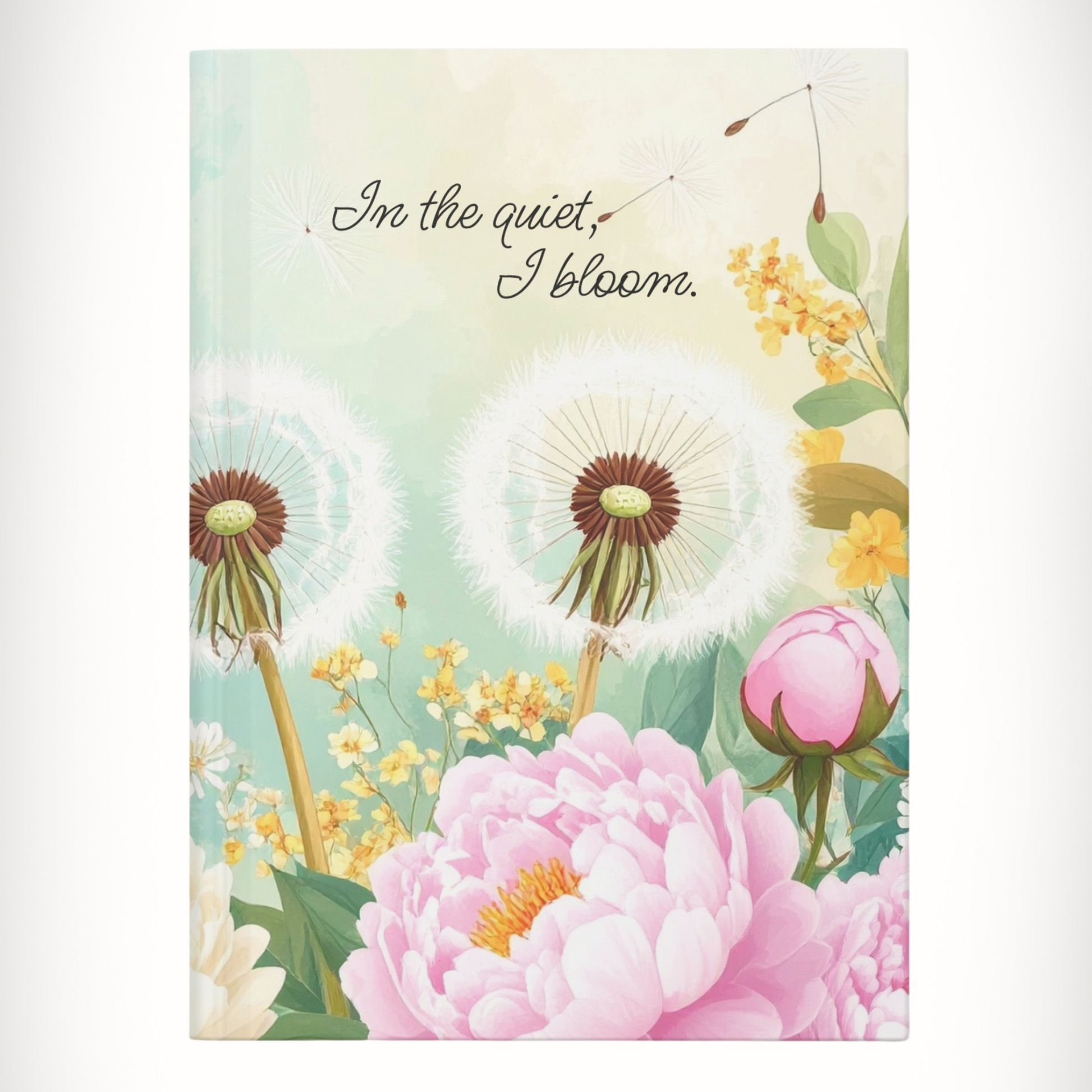 Hardcover floral journal with text “In the Quiet, I Bloom.” centered on cover.
