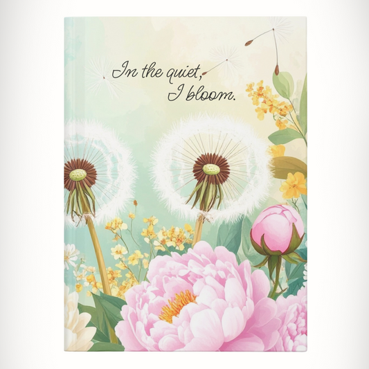 Hardcover floral journal with text “In the Quiet, I Bloom.” centered on cover.