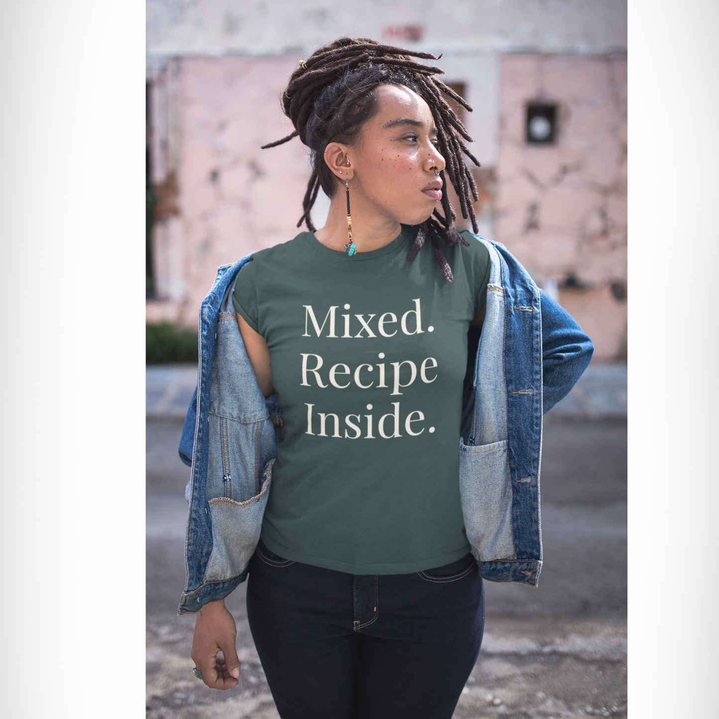 Woman wearing Forest Green Signature Tee with white 'Mixed. Recipe Inside.' text outdoors.