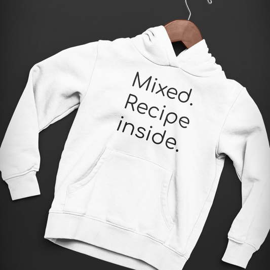 White youth hoodie with bold “Mixed. Recipe Inside.” stacked text design on a dark background