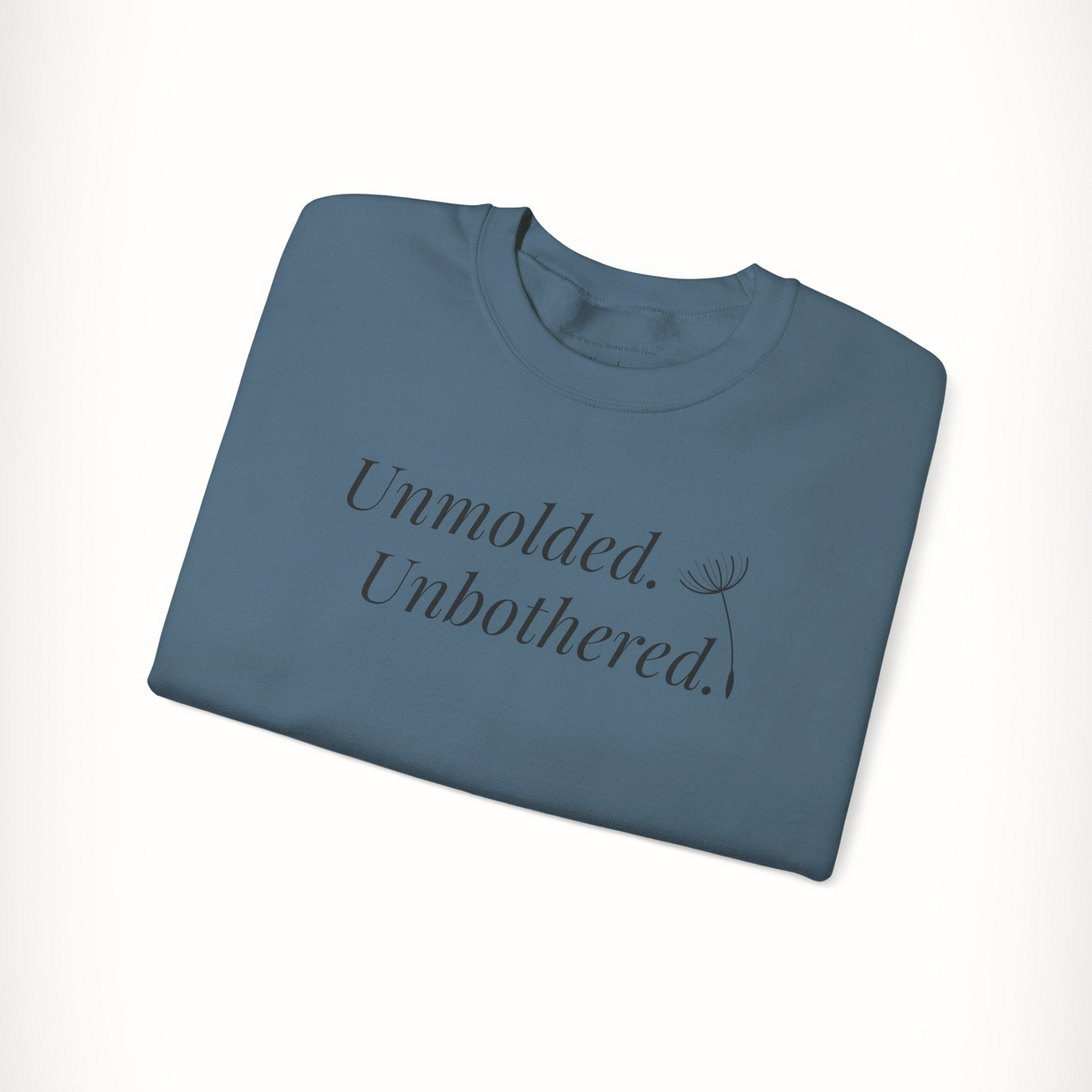 Blue Unmolded. Unbothered. sweatshirt with bold front text, folded flat.