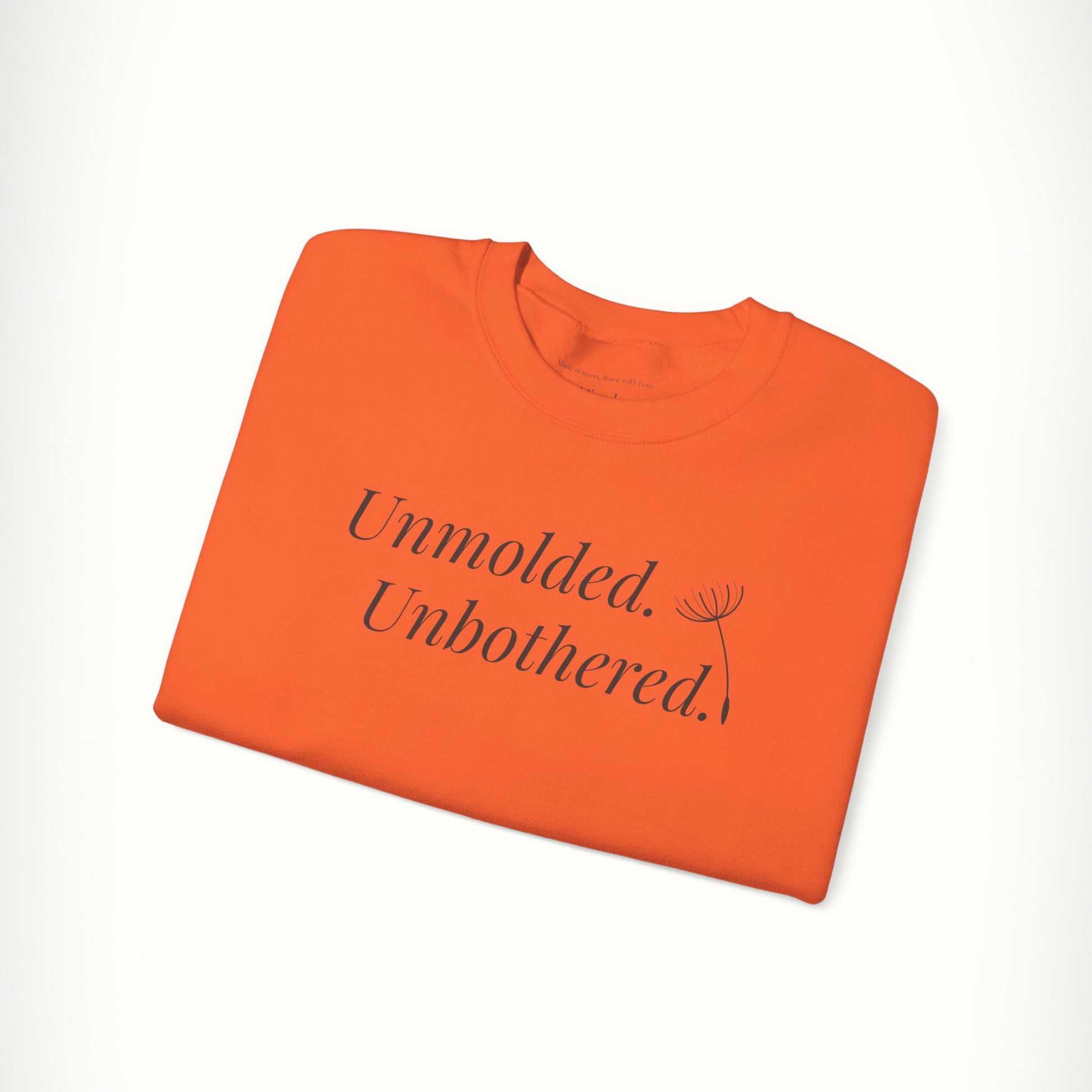 Orange Unmolded. Unbothered. sweatshirt with bold front text, folded flat.