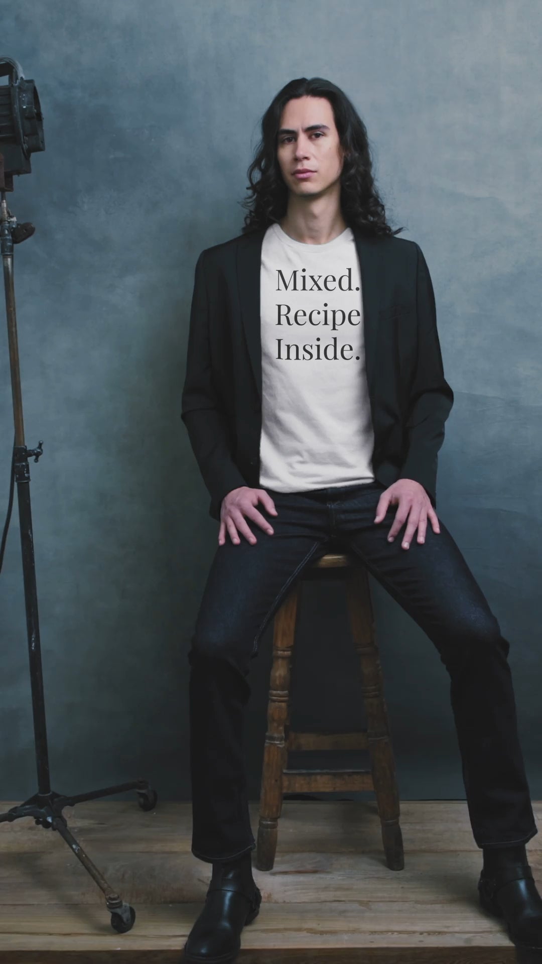 Short video of a man wearing white Signature Tee, dark jeans and black jacket.